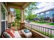 Cozy covered patio with comfortable seating, brick accents, and neighborhood views at 2870 W Riverwalk Cir # B, Littleton, CO 80123