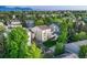 An aerial view showcases the home's large yard and its location in a desirable neighborhood with mature trees at 6973 Daventry Pl, Castle Pines, CO 80108