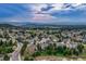 Beautiful aerial view of the neighborhood with mountain views and winding roads at 6973 Daventry Pl, Castle Pines, CO 80108