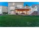Spacious backyard featuring patio with overhead cover and upper level deck at 6973 Daventry Pl, Castle Pines, CO 80108