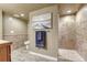 Bathroom with a tiled walk-in shower, toilet, and artwork at 6973 Daventry Pl, Castle Pines, CO 80108