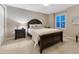 Cozy bedroom with a queen-size bed, dark wood accents, and a view at 6973 Daventry Pl, Castle Pines, CO 80108