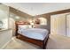 Warm bedroom with a large bed, track lighting, and neutral color palette at 6973 Daventry Pl, Castle Pines, CO 80108