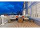 Outdoor deck featuring cushioned seating around a modern fire pit at 6973 Daventry Pl, Castle Pines, CO 80108