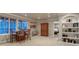 Dining room with wood table, built-in shelves, and open access to the bedroom creating a seamless transition at 6973 Daventry Pl, Castle Pines, CO 80108
