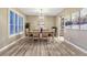 Formal dining room with modern lighting and large windows at 6973 Daventry Pl, Castle Pines, CO 80108
