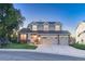 Charming two-story home with a three car garage, landscaped yard, and inviting front porch at 6973 Daventry Pl, Castle Pines, CO 80108