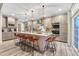 Gorgeous kitchen with stainless appliances, marble countertops, and island seating at 6973 Daventry Pl, Castle Pines, CO 80108