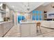 Open-concept kitchen featuring an island with granite counters, stainless appliances, and a breakfast bar at 6973 Daventry Pl, Castle Pines, CO 80108