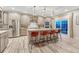 Modern kitchen with stainless steel appliances and large island with seating at 6973 Daventry Pl, Castle Pines, CO 80108