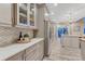 Spacious kitchen with white quartz countertops, stainless appliances, stylish backsplash, and hardwood flooring at 6973 Daventry Pl, Castle Pines, CO 80108