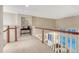 Open landing overlooking the living room with plenty of natural light at 6973 Daventry Pl, Castle Pines, CO 80108