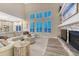 Cozy living room with fireplace, large windows, and open floor plan at 6973 Daventry Pl, Castle Pines, CO 80108