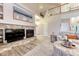 Living room with stone fireplace and open to above at 6973 Daventry Pl, Castle Pines, CO 80108