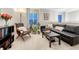Comfortable loft featuring a black leather sofa, stylish furnishings, and ample natural light at 6973 Daventry Pl, Castle Pines, CO 80108
