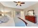 Well-lit main bedroom featuring a bed, area rug, and dresser with a mirror at 6973 Daventry Pl, Castle Pines, CO 80108