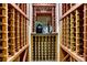 Intricate wooden wine storage with decorative accents at 6973 Daventry Pl, Castle Pines, CO 80108