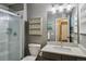 Contemporary bathroom featuring a glass-enclosed shower, modern fixtures, and neutral color palette at 9836 W Freiburg Dr # 4E, Littleton, CO 80127