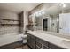 Modern bathroom featuring a soaking tub, large vanity, and separate shower with tile surround at 9836 W Freiburg Dr # 4E, Littleton, CO 80127