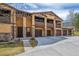 Attractive townhouse complex showcasing stone accents, private balconies, and individual garages at 9836 W Freiburg Dr # 4E, Littleton, CO 80127
