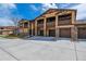 Townhouse complex with private balconies, garages, and stone accents offering a visually appealing exterior at 9836 W Freiburg Dr # 4E, Littleton, CO 80127
