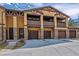 Beautiful townhouse complex with private balconies, garages, and stone accents, enhancing curb appeal at 9836 W Freiburg Dr # 4E, Littleton, CO 80127