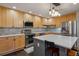 Modern kitchen with stainless steel appliances, a center island with breakfast bar, and ample cabinet space at 9836 W Freiburg Dr # 4E, Littleton, CO 80127