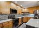 Well-equipped kitchen featuring stainless steel appliances, mosaic backsplash, and sleek countertops for cooking and entertaining at 9836 W Freiburg Dr # 4E, Littleton, CO 80127