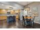 Modern kitchen and dining area featuring stainless steel appliances, a breakfast bar, and unique lighting at 9836 W Freiburg Dr # 4E, Littleton, CO 80127