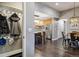 Open-concept kitchen with stainless steel appliances, an island with seating, and hardwood flooring throughout at 9836 W Freiburg Dr # 4E, Littleton, CO 80127