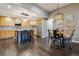 Open floor plan connecting the kitchen and dining area, with modern appliances and stylish decor at 9836 W Freiburg Dr # 4E, Littleton, CO 80127