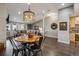 Bright living area featuring a dining table, decorative lighting, and comfortable seating at 9836 W Freiburg Dr # 4E, Littleton, CO 80127