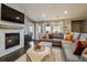Bright living room with fireplace, mounted TV, and comfortable seating perfect for relaxing or entertaining at 9836 W Freiburg Dr # 4E, Littleton, CO 80127