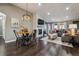 Open-concept living room with hardwood floors, fireplace, and modern lighting at 9836 W Freiburg Dr # 4E, Littleton, CO 80127