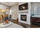 Inviting living space featuring a fireplace, flat screen TV and views of dining area and modern chandelier at 9836 W Freiburg Dr # 4E, Littleton, CO 80127