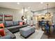 Comfortable living space showcasing an open layout with a sectional sofa and dining area connected to the kitchen at 9836 W Freiburg Dr # 4E, Littleton, CO 80127