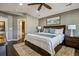 Spacious main bedroom featuring hardwood floors, ceiling fan, a large window, and ensuite access at 9836 W Freiburg Dr # 4E, Littleton, CO 80127