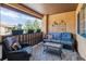 Cozy covered patio featuring a wicker sofa and chair set for relaxing outdoors at 9836 W Freiburg Dr # 4E, Littleton, CO 80127