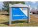 Community sign for TrailMark Park with lush landscaping, inviting you to explore the recreational area at 9836 W Freiburg Dr # 4E, Littleton, CO 80127
