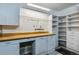 Functional workshop area features a large workbench, pegboard, and shelving for storage and organization at 9836 W Freiburg Dr # 4E, Littleton, CO 80127
