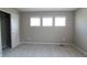 Neutral bedroom featuring 3 windows and a sliding-door closet at 3427 Cade Ct, Castle Rock, CO 80104