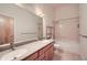 Bathroom featuring a double vanity, large mirror, and a bathtub and shower combination at 7700 E 29Th Ave # 404, Denver, CO 80238