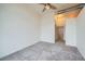 Well-lit bedroom with neutral carpet, ceiling fan, and connections for wall lighting at 7700 E 29Th Ave # 404, Denver, CO 80238
