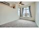 Spacious bedroom with scenic views from two windows and industrial-style ceiling details at 7700 E 29Th Ave # 404, Denver, CO 80238