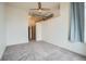 Generous bedroom featuring a ceiling fan, neutral carpet, and easy access to other rooms at 7700 E 29Th Ave # 404, Denver, CO 80238