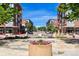 Attractive outdoor community space with colorful flowers, walkways and residential buildings nearby under a blue sky at 7700 E 29Th Ave # 404, Denver, CO 80238