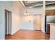 Well-lit dining area with an elegant chandelier and hardwood floors, seamlessly connected to the kitchen at 7700 E 29Th Ave # 404, Denver, CO 80238