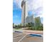 Modern building with a tall tower under a blue sky with landscaping and parking at 7700 E 29Th Ave # 404, Denver, CO 80238