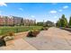 A scenic outdoor space featuring a walkway, flower planters, and views of nearby buildings at 7700 E 29Th Ave # 404, Denver, CO 80238