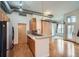 Modern kitchen with stainless steel appliances, a breakfast bar, and hardwood floors at 7700 E 29Th Ave # 404, Denver, CO 80238
